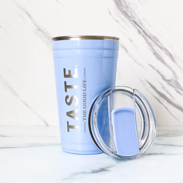 Light blue tumbler with 'TASTE THE GOOD LIFE' text and clear lid on a white background