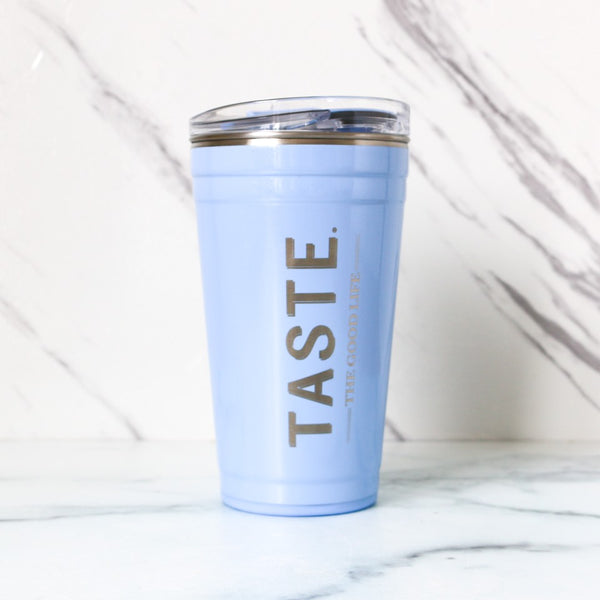 Light blue tumbler with 'TASTE' text on a marble surface