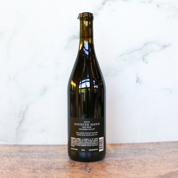 Wine bottle with label on a wooden surface and marble background