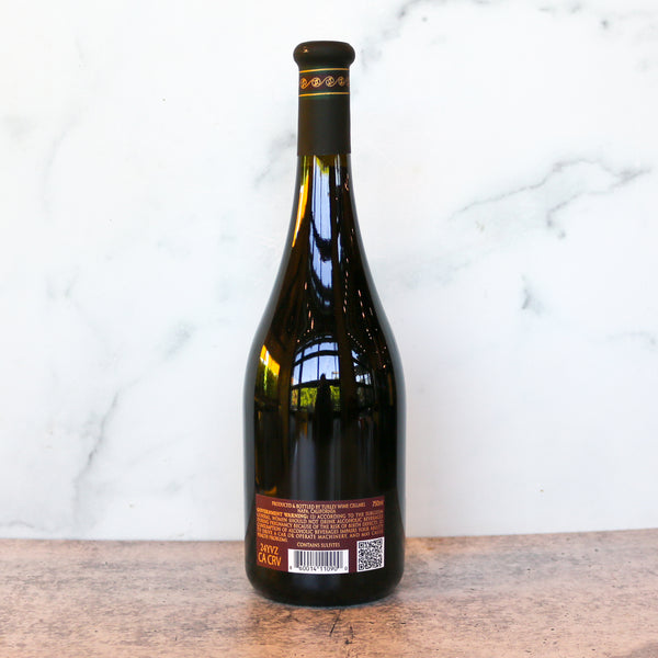 Wine bottle with label on a wooden surface and marble background