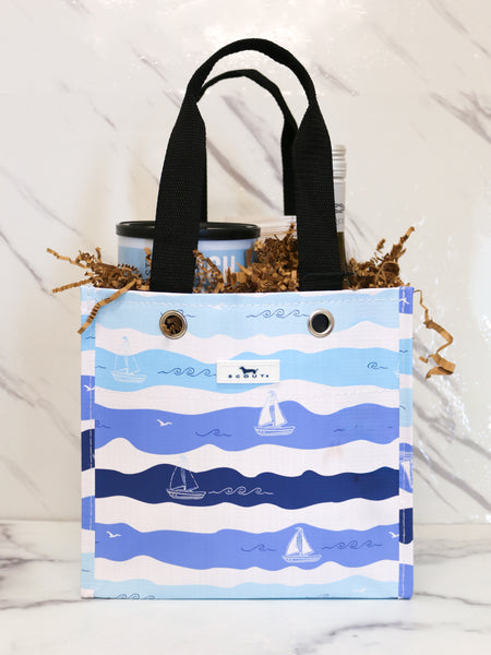 TASTE's Sail into Summer Gift in a blue Scout bag with Wine and Snacks