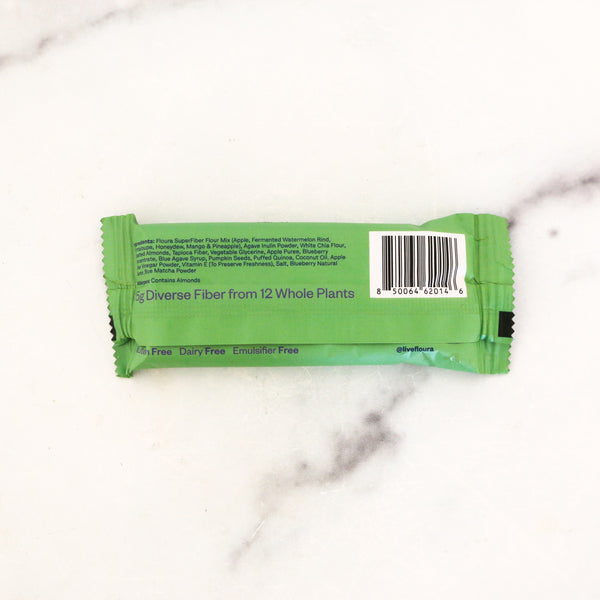 Blue and Green Matcha fiber bar on a marble background, showing ingredients