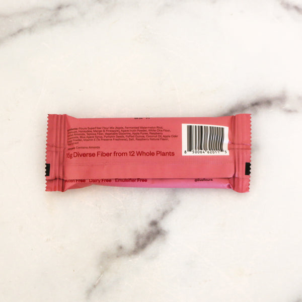 Pink protein bar with a label on a marble surface