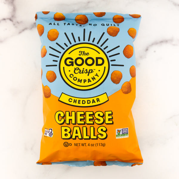 Packaging of The Good Crisp Company Cheddar Cheese Balls on a marble background