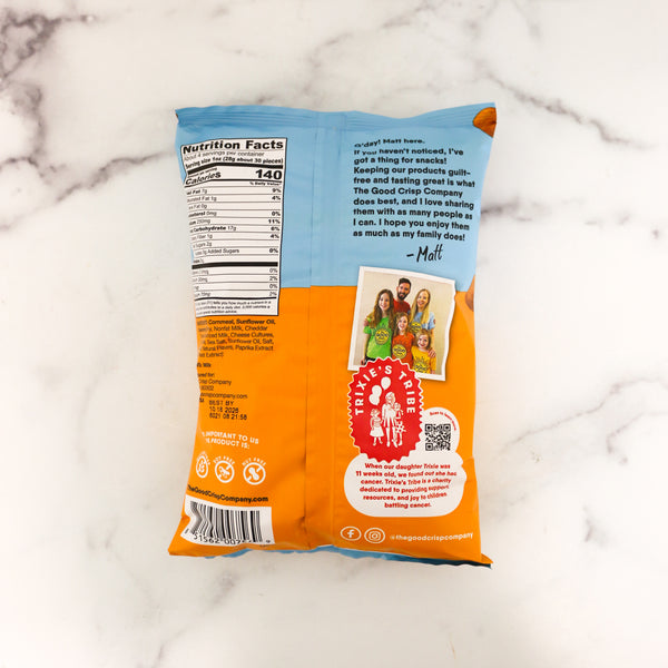 Back view of a snack package with branding and product details on a marble surface