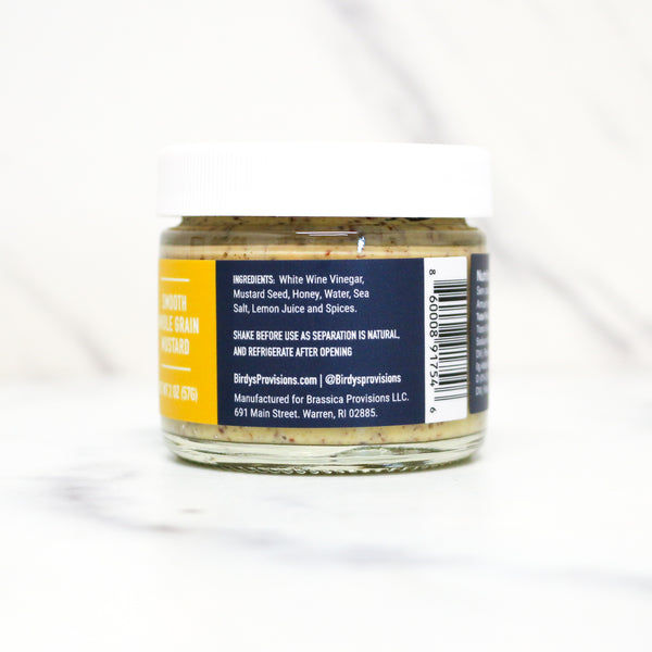 Jar of mustard with label on a white background