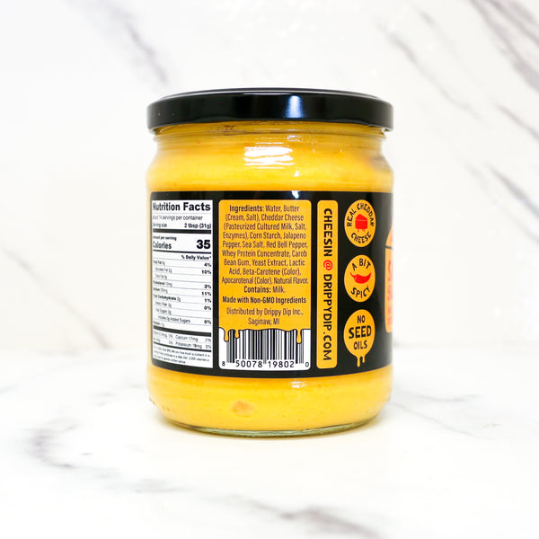 Jar of cheese sauce with label on a white background