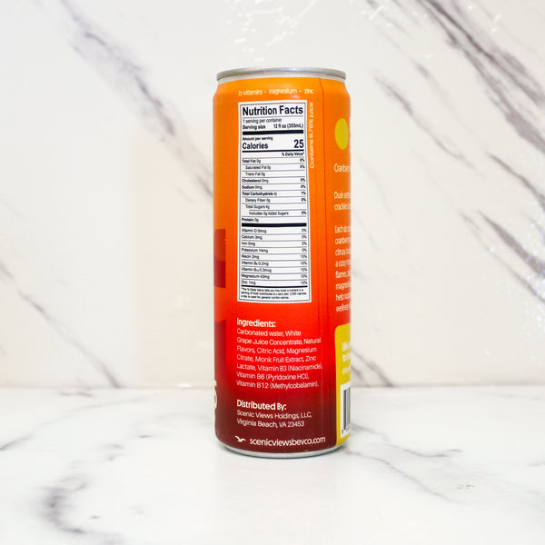 Orange can with nutrition facts label on a white marble surface