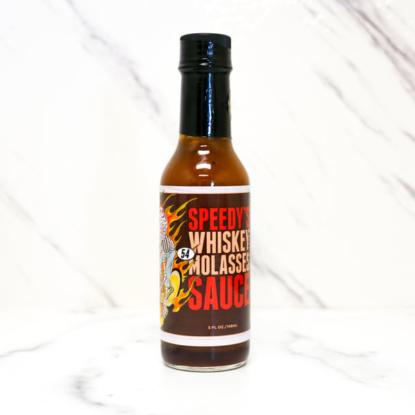 Bottle of Speedy's Whiskey Molasses Sauce on a white background