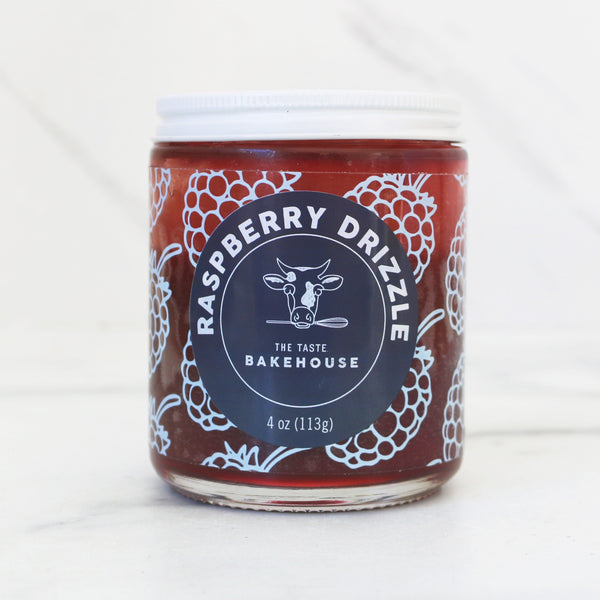 Jar of Raspberry Drizzle from The Taste Bakehouse on a white background