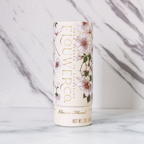 Flower co. garnishing salt with classic floral pattern, cylindrical packaging on a marble background