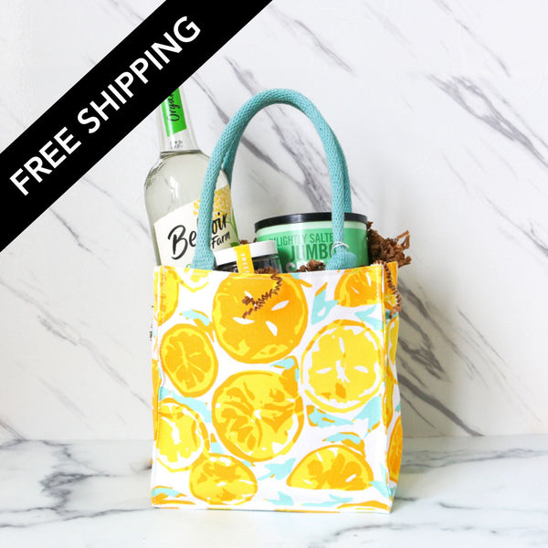 Fabric bag with lemon pattern containing drinks on a marble surface, with 'Free Shipping' text overlay.