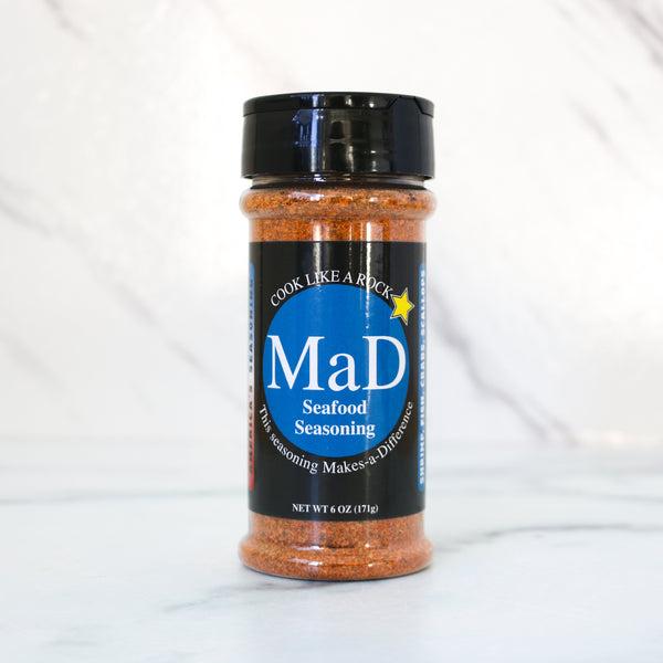 One bottle of MaD Blue seasoning on a white marble background. Spice jar with label on a white background. All MaD Seasonings come from Matt Starcher, aka The MattDad, aka @themattdad, a culinary pro, instructor and contestant on Next Level Chef with Gordon Ramsay (Season 5). That chef-driven pedigree shows in every blend.  