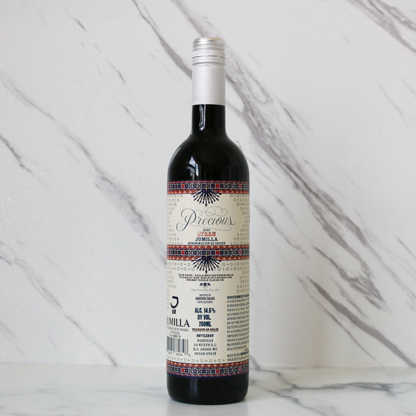 Wine bottle with a decorative label on a marble surface