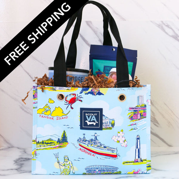 Colorful tote bag with illustrations and 'Scout VA' branding on a marble surface.