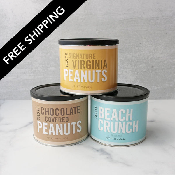 Three cans of peanuts with different flavors on a white surface.