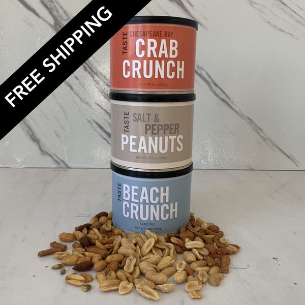 Three cans of 'Crab Crunch' and 'Beach Crunch' peanuts on a marble surface with 'Free Shipping' text.