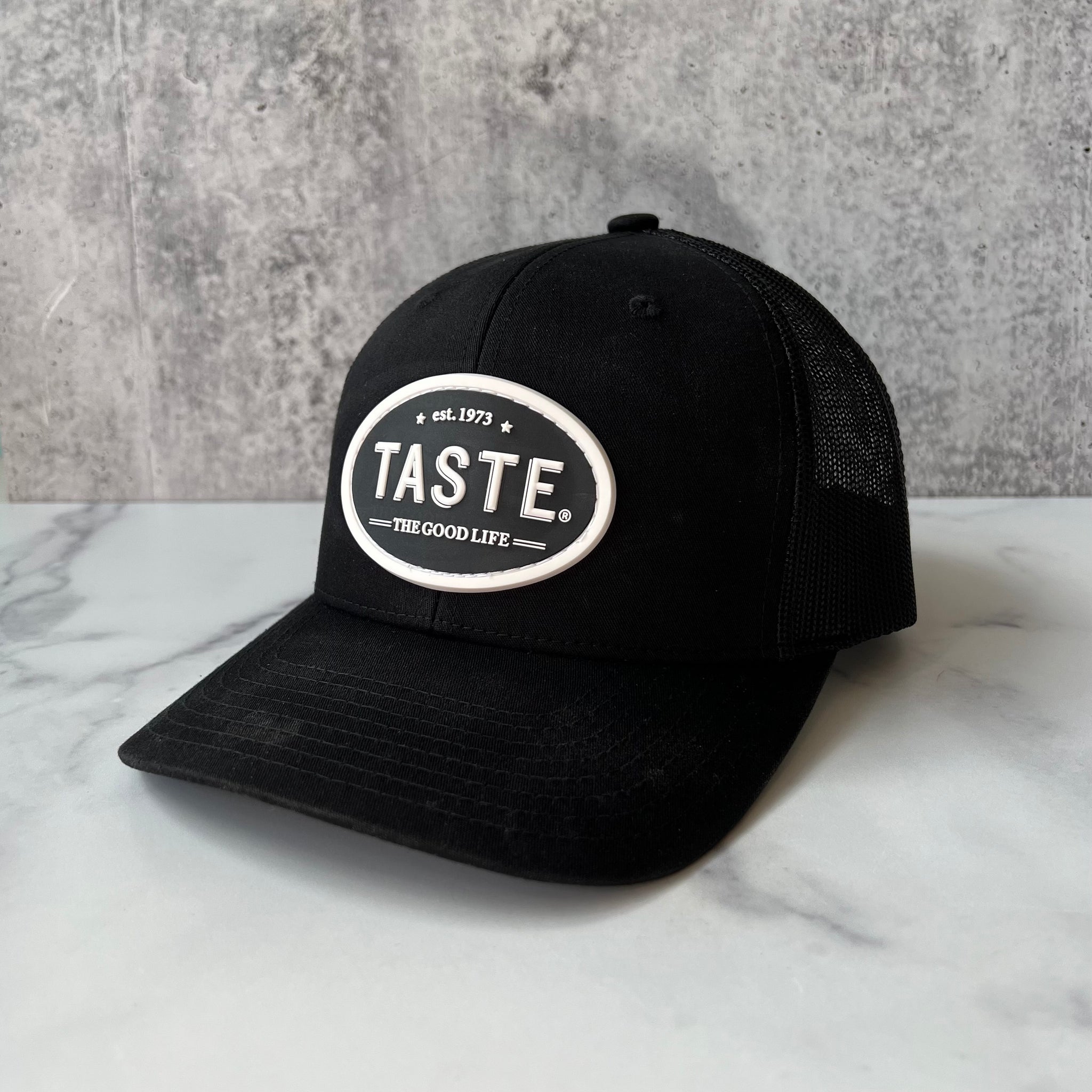 TASTE Trucker Hat –  The Good Life, est. 1973 logo (Black)