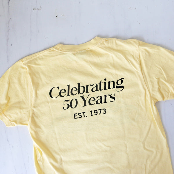 a yellow t-shirt with the classic TASTE logo