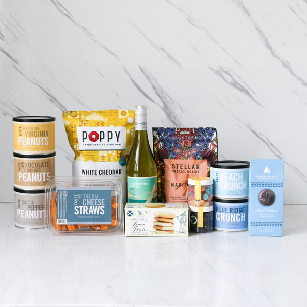 Assorted food products from TASTE beachy keen gift  including snacks and drinks on a white surface with a light gray background