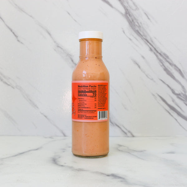 Bottle of TASTE Best ever sauce with a label on a marble background