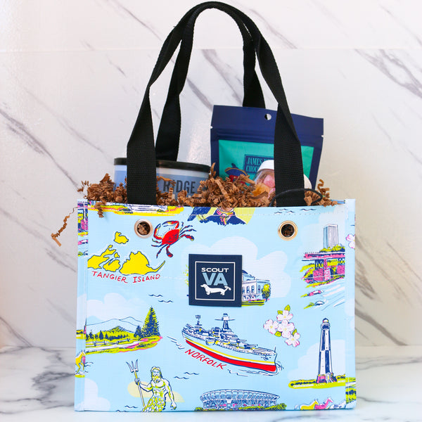 Assorted food products including a Cans of Virginia peanuts, a container of TASTE cheese straws, and jars on a marble surface, all packed in a SCOUT tiny package bag.