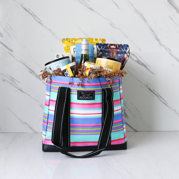 TASTE Beachy Keen striped tote bag filled with snacks on a white background