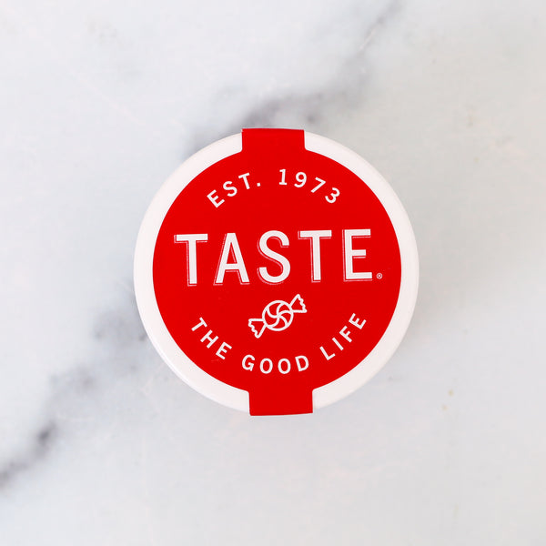 Red circular logo with 'Taste' branding on a marble background