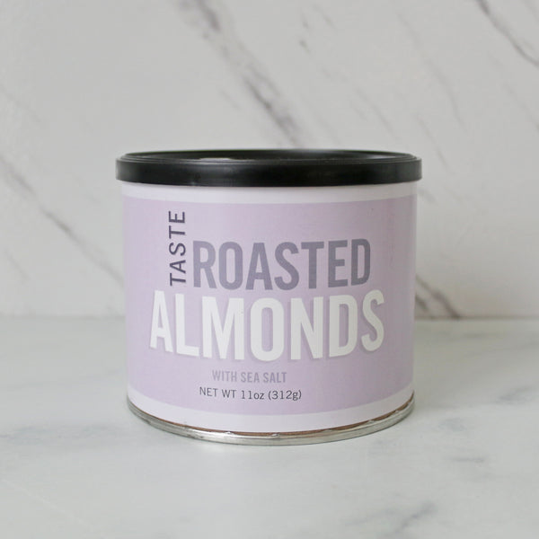 A can of TASTE Roasted Almonds on a marble surface.