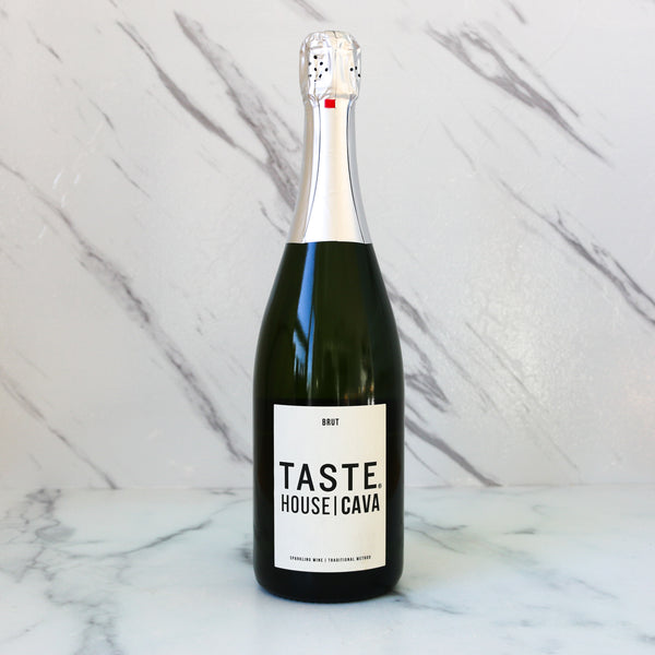 Bottle of TASTE House Cava sparkling wine on a marble background