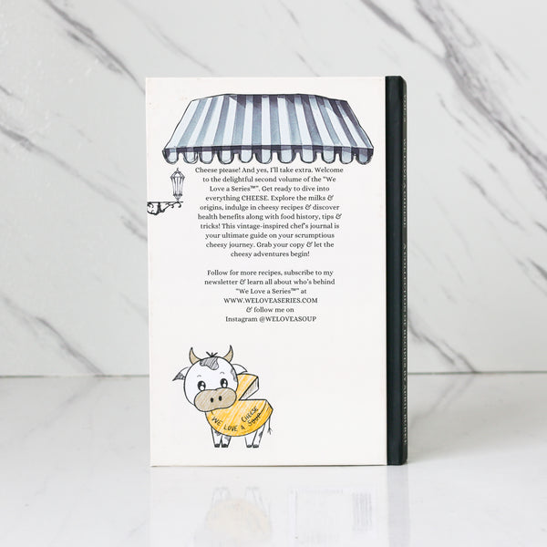  Chef April Burke’s Book titled 'We Love A Cheese' showing the rear cover photo on a white marble background