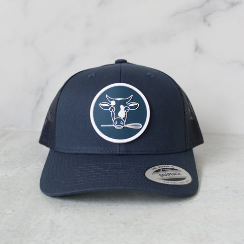 TASTE Bakehouse Trucker Hat – Cow Logo (Navy)