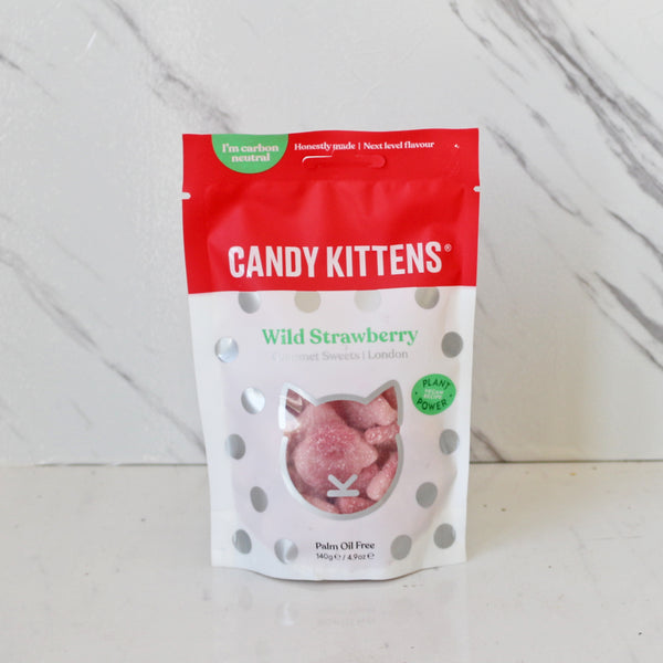A bag of Candy Kittens Wild Strawberry gummies displayed against a marble background.