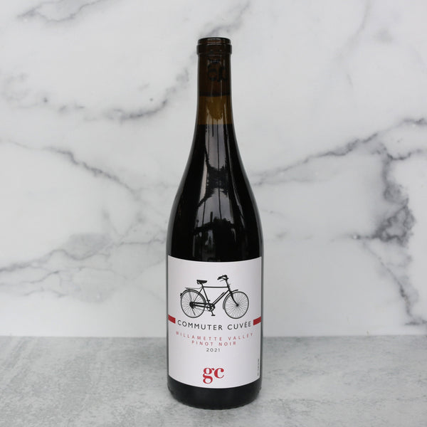 bottle of commuter cuvee on a white marble background