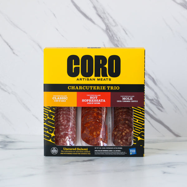 Box of CORO Artisan Meats Charcuterie Trio on a marble background
