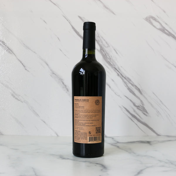 Wine bottle with a label on a marble surface