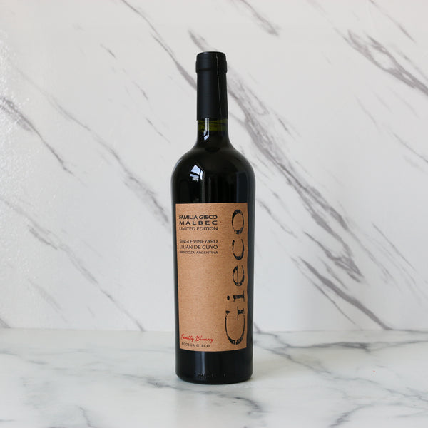 Wine bottle with a label on a marble surface