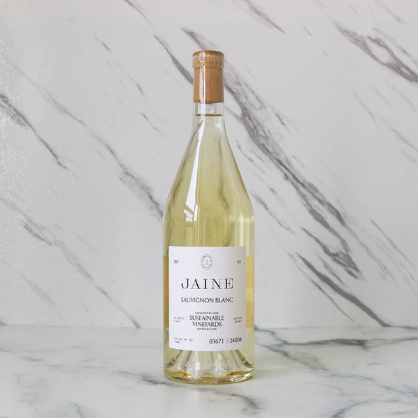 Bottle of Jaine Sauvignon Blanc wine on a marble background