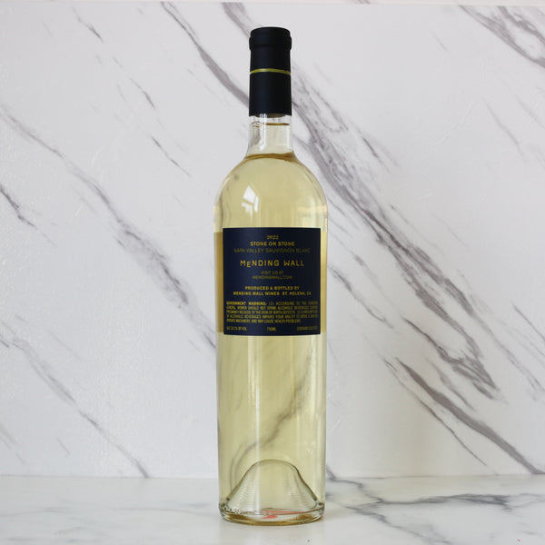 Bottle of white wine with a blue label on a marble surface