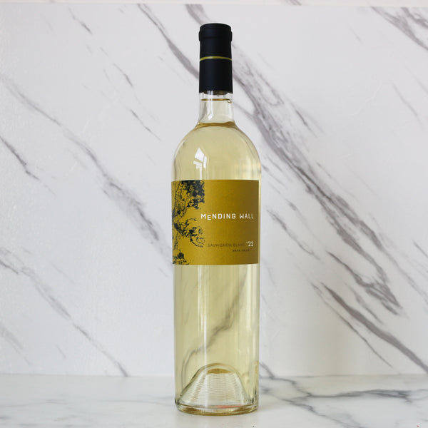 Bottle of white wine with a yellow label on a marble background