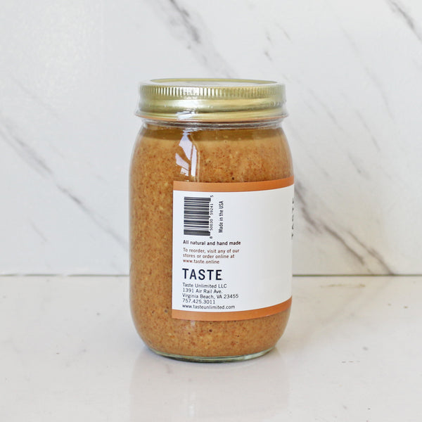 a jar of TASTE Honey Roasted Peanut Butter on a white tablel