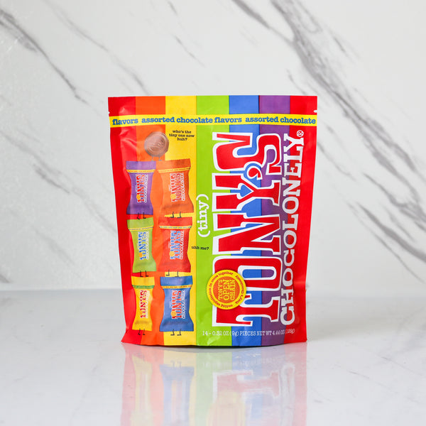 Colorful package of Tony's Chocolonely chocolate bars on a white background