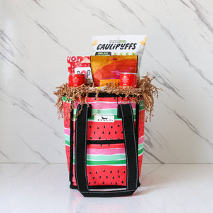 Tote bag with watermelon pattern filled with snacks on a white background
