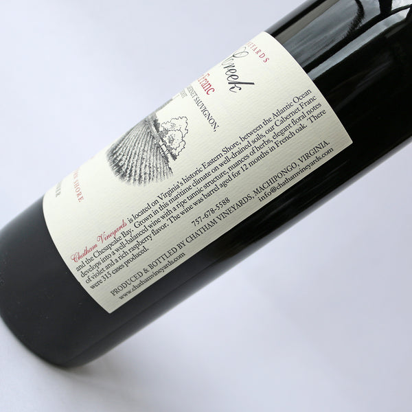 A bottle of Church Creek Cabernet Franc wine with a red cap and label, indicating it is a product of Chatham Vineyards, Eastern Shore, Virginia.