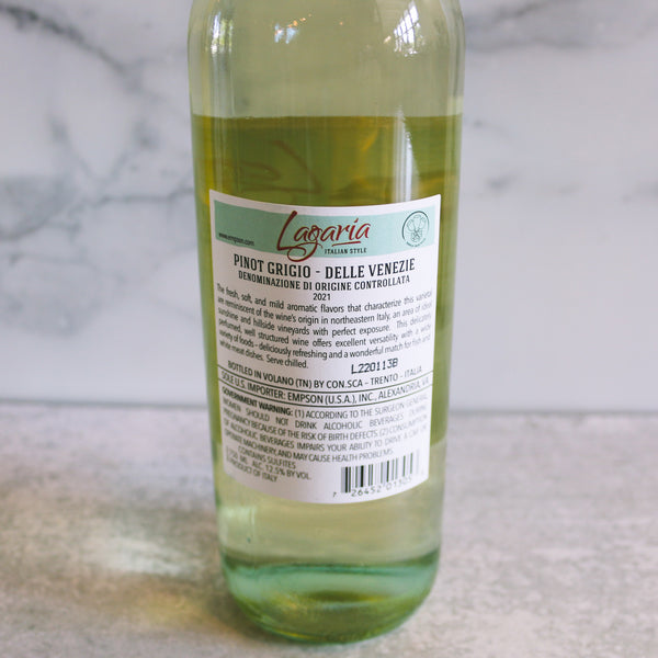 the back of a bottle of Lagaria Delle Venezie Pinot Grigio wine positioned in front of a marble background.
