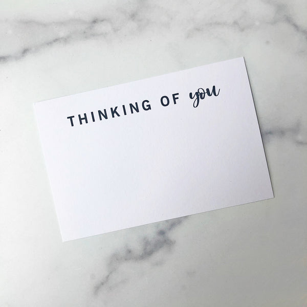 A gift enclosure card with the text 'Thinking of You"