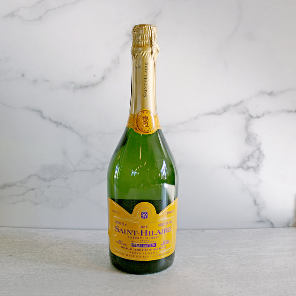 A Bottle of Saint-Hilaire, Blanquette De Limoux Blanc De Blanc shown on a white marble background available at TASTE.online and TASTE Stores across Virginia