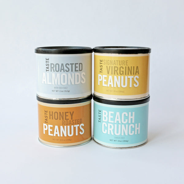 Four cans of TASTE brand nuts against a white background, with labels indicating different types of nuts: Virginia Peanuts, Beach Crunch, Honey Roasted Peanuts, and Roasted Almonds.