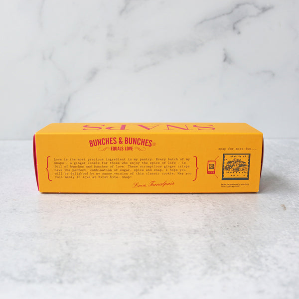 A box of Bunches & Bunches Snaps Ginger Cookies on a marble surface.