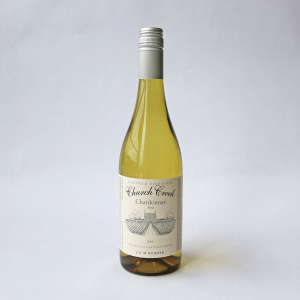 A bottle of Church Creek Chardonnay wine Steel aged with a white label, displaying the name of the winery and the type of wine.